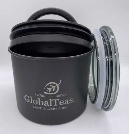 A black canister with a silicone lid and glass cover, featuring the GlobalTeas logo, designed for tea storage.
